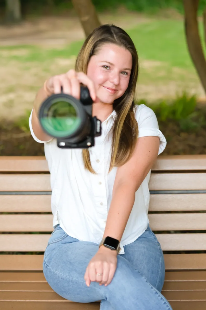 Leah Taylor of Taylor Made Media holding her camera outdoors